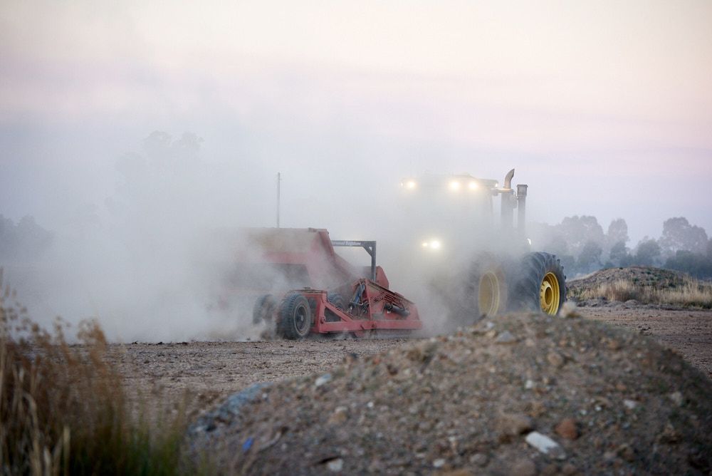 A Tractor Pulling a Piece of Farm Machinery — Quarrell Civil Construction In Congupna, VIC