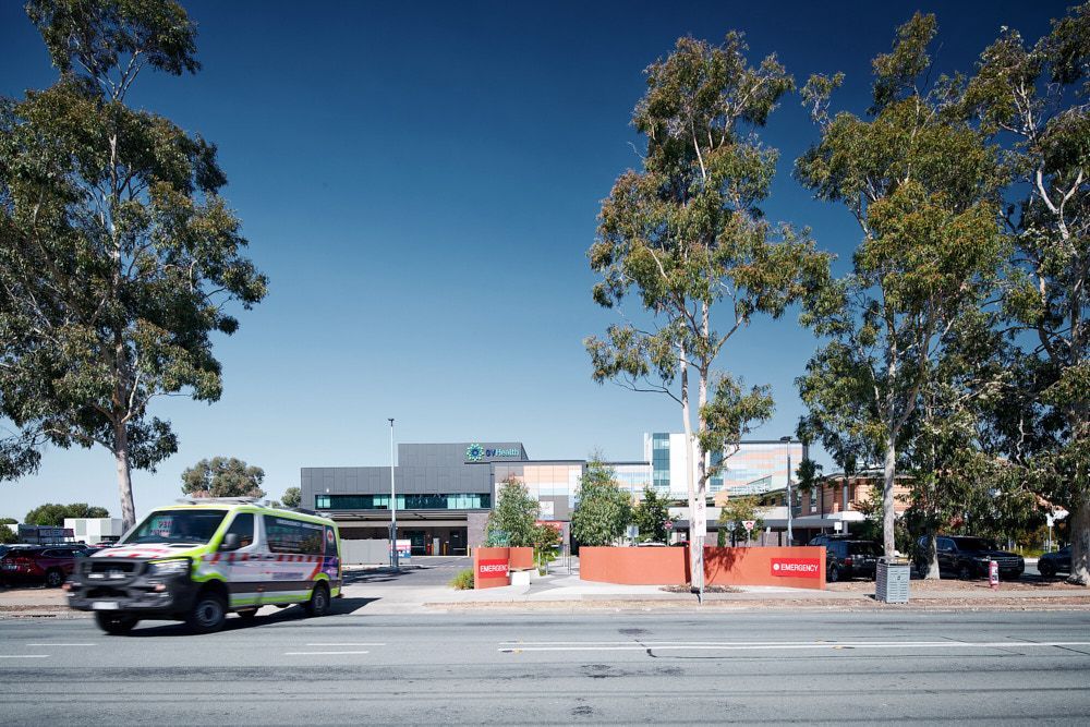 Ambulance On Road in Front of Modern Building — Quarrell Civil Construction In Congupna, VIC