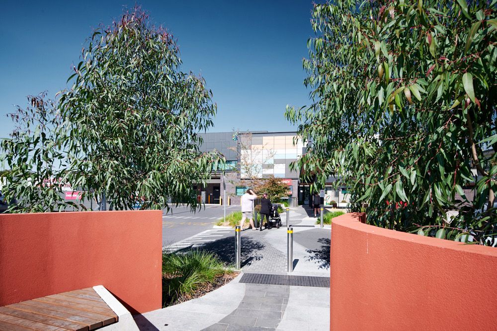 Red Walls Frame a Walkway to a Modern Building — Quarrell Civil Construction In Congupna, VIC