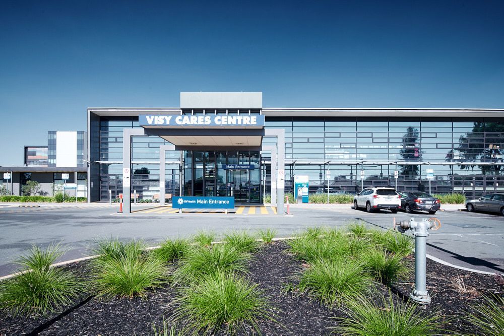 Vistry Cares Centre Exterior With Glass Windows and a Blue Sky — Quarrell Civil Construction In Congupna, VIC