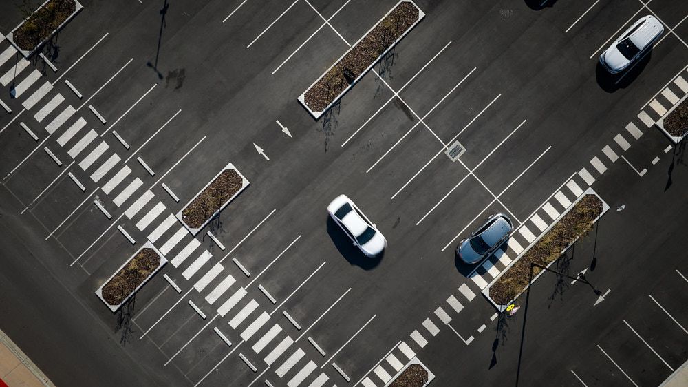 Overhead View Of A Mostly Empty Parking Lot With Several Cars Parked — Quarrell Civil Construction In Congupna, VIC