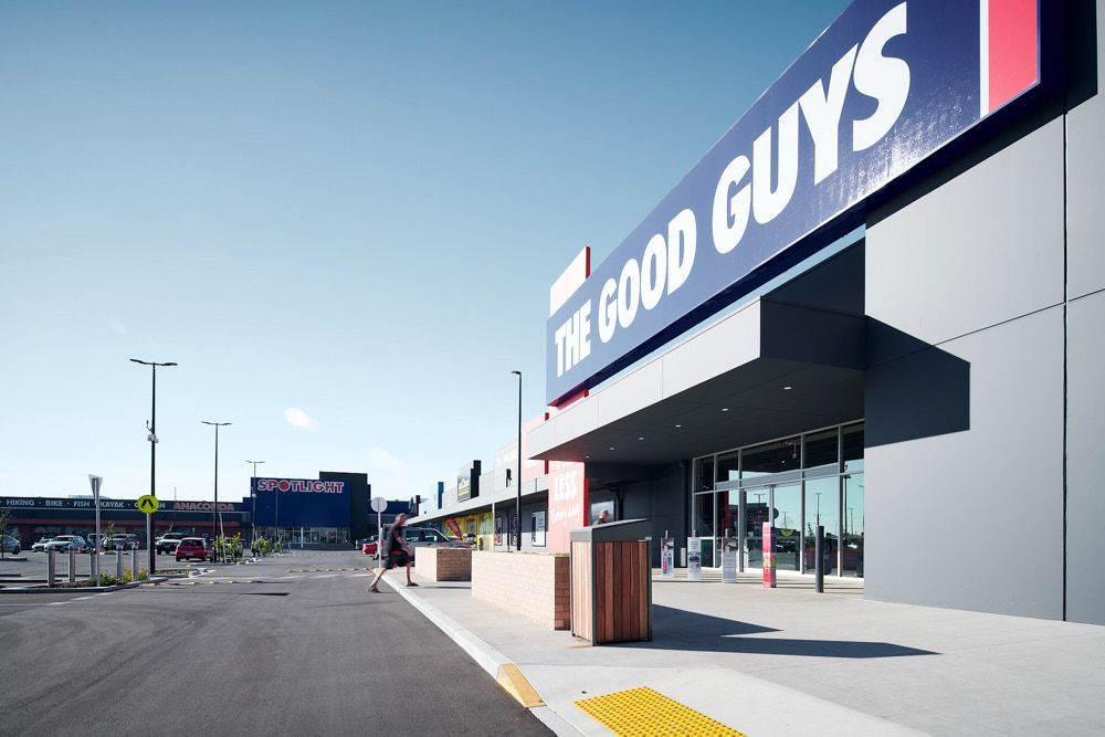 A Person Walks Toward the Entrance of the Good Guys Store — Quarrell Civil Construction In Congupna, VIC