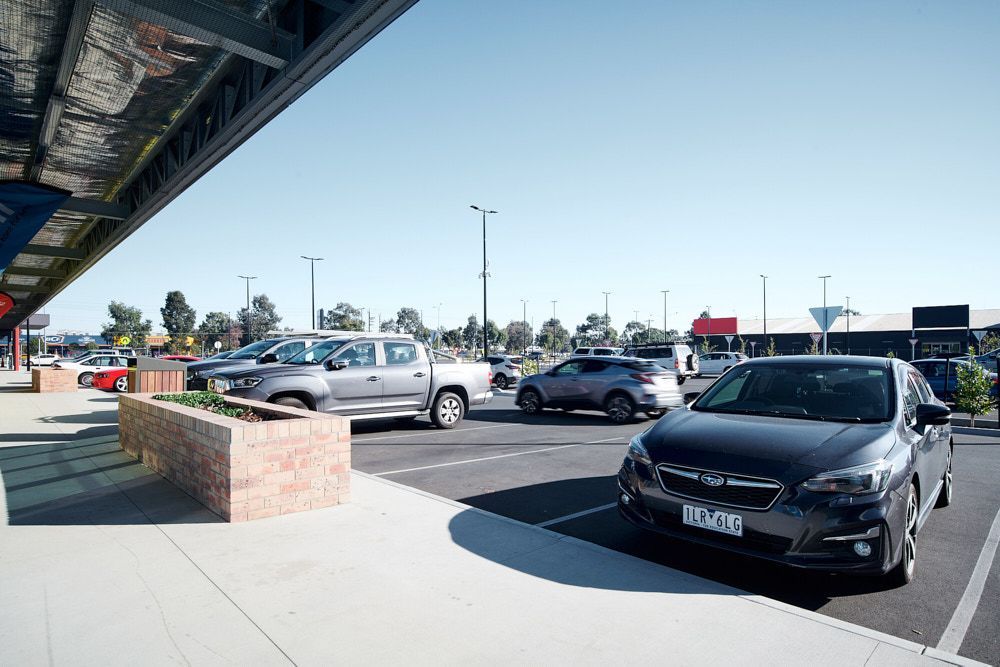 A Sunny Outdoor Parking Lot With a Brick Planter Box — Quarrell Civil Construction In Congupna, VIC