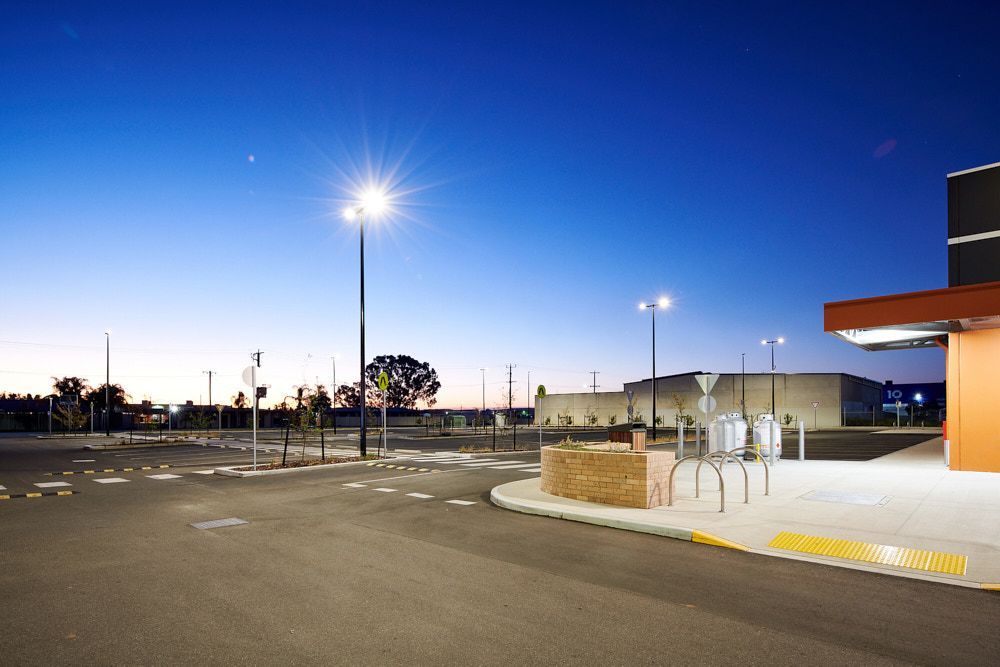 An Empty Parking Lot at Dusk, Featuring Tall Light Poles — Quarrell Civil Construction In Congupna, VIC
