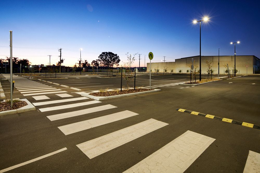 An Empty Outdoor Parking Lot at Dusk With a Prominent Pedestrian Crosswalk — Quarrell Civil Construction In Congupna, VIC