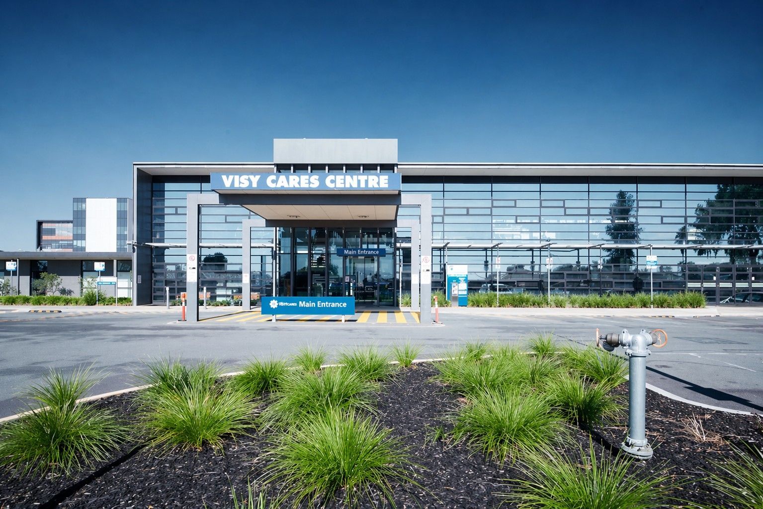 Modern Entrance, Glass Facade, Blue Sky, Cars Parked — Quarrell Civil Construction In Congupna, VIC