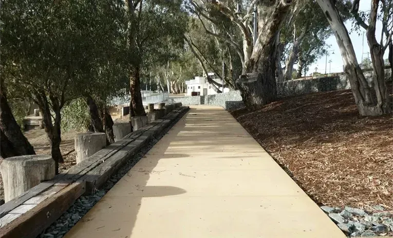 A Smooth, Light-colored Walking Path Lined With Dark Wooden Posts — Quarrell Civil Construction In Congupna, VIC