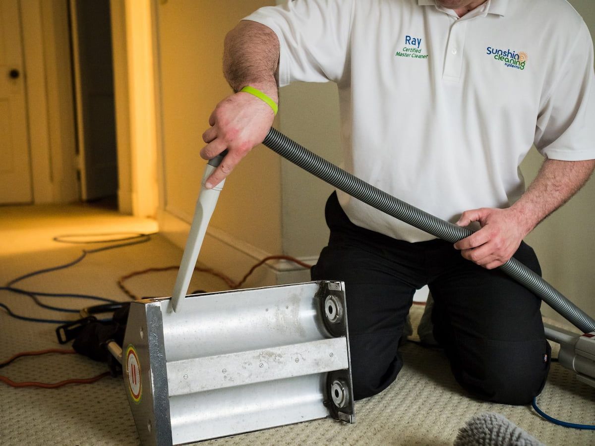 Ray DeMeo using a professional carpet brush machine in a Waltham home