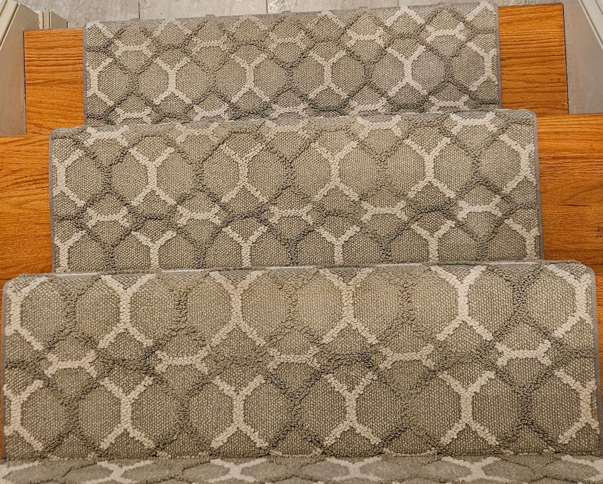 Beige patterned carpet stairs after professional deep cleaning, showing restored pattern definition and removed embedded dirt