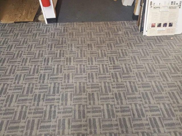 Office entrance commercial carpet after low-moisture spot removal, with the coffee stain removed