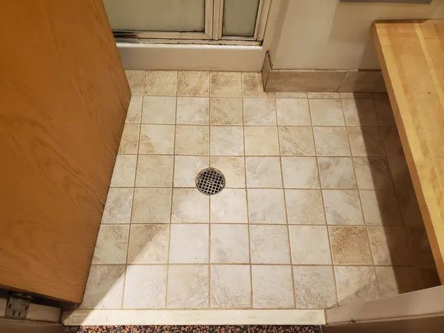 Same textured tile floor after deep cleaning, with clean tile and bright, even grout lines