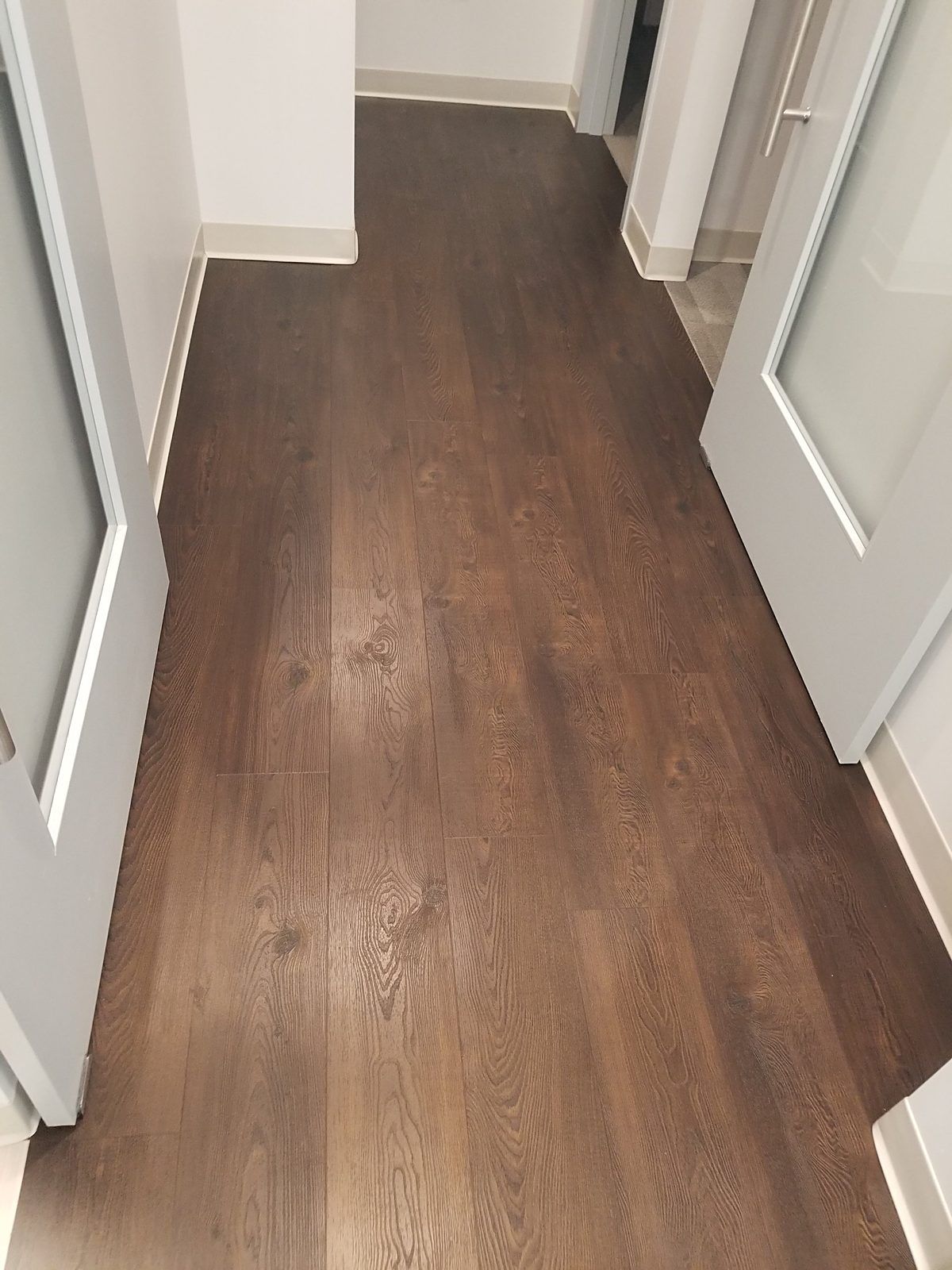 Luxury vinyl plank floor in a Waltham, MA dental office after the coating was safely removed, showing restored wood grain and finish