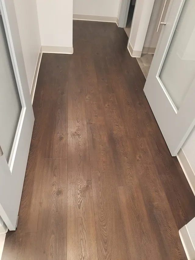 Luxury vinyl plank floor in a Waltham, MA dental office after the coating was safely removed, showing restored wood grain and finish