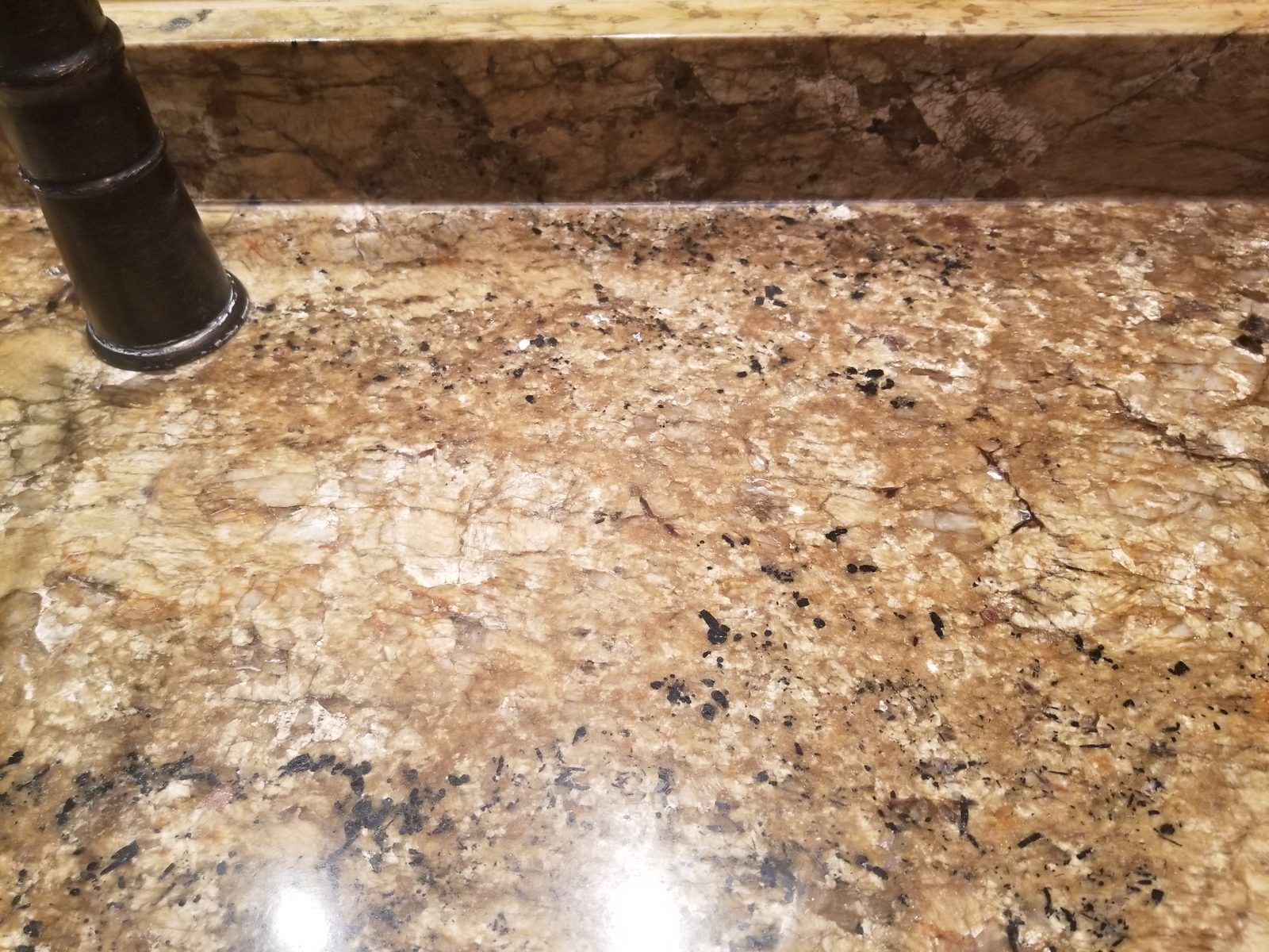 Same granite vanity with the faucet area clean and the stone's color restored, Needham MA