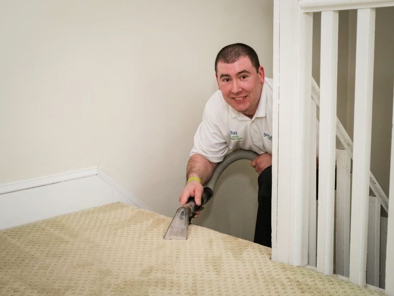 Ray DeMeo, Master Textile Cleaner, professionally cleaning carpet stairs in Greater Boston home with extraction equipment