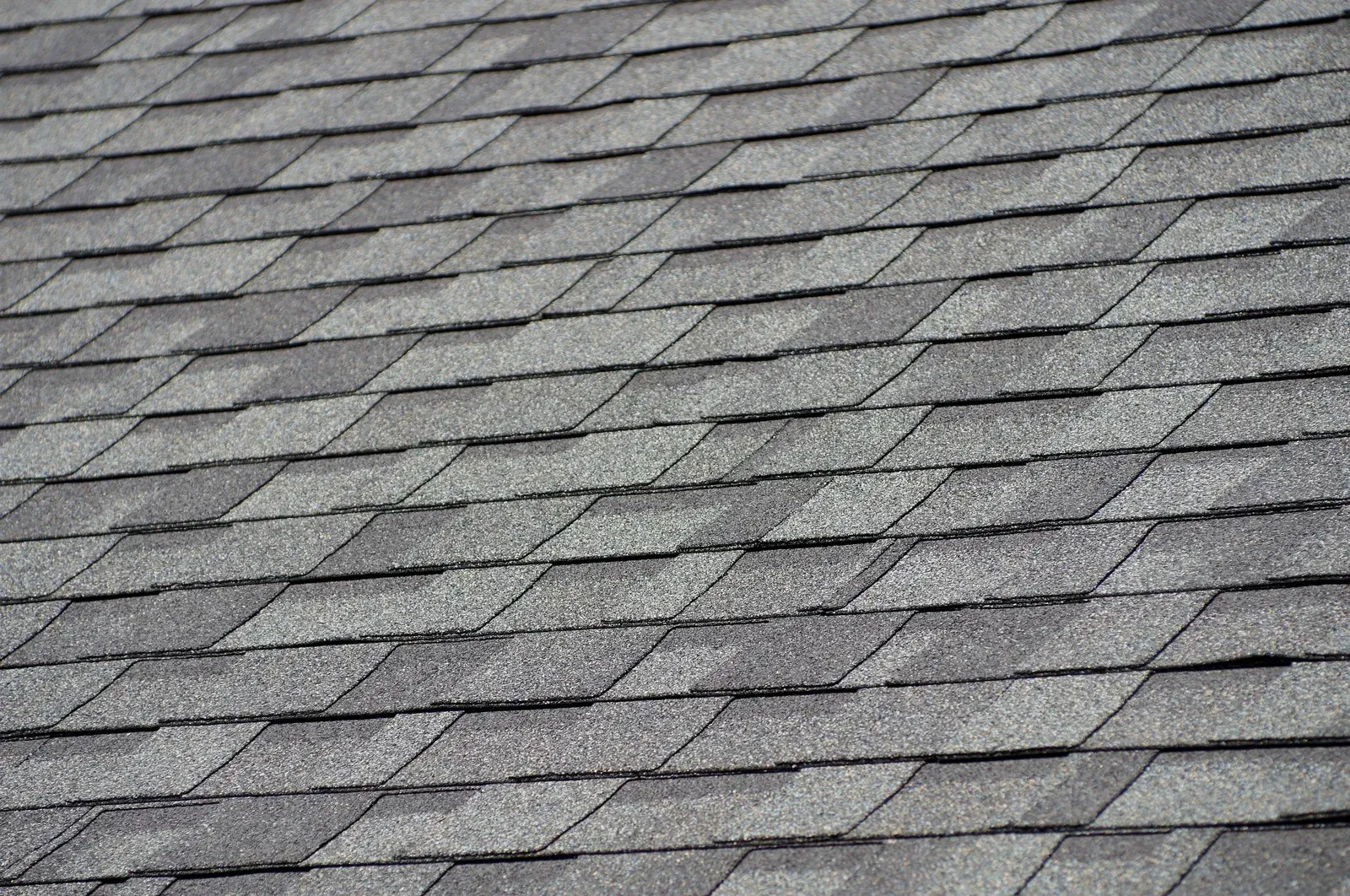 Gray shingled roof with overlapping asphalt shingles