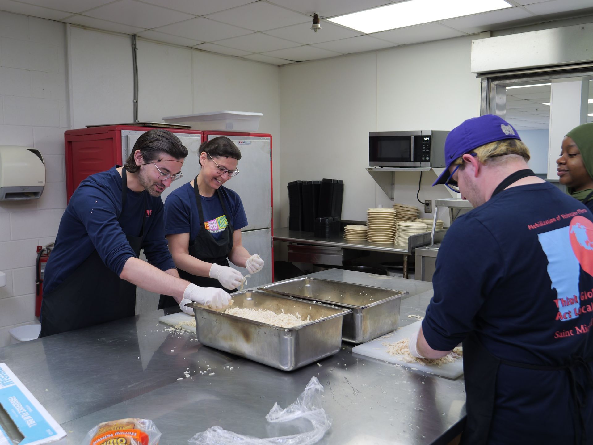 A group of people are preparing food in a kitchen.