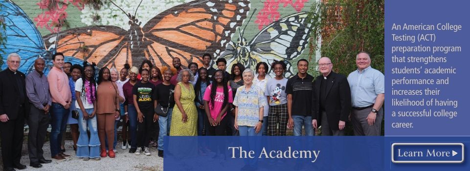 A group of people are posing for a picture in front of a butterfly mural.