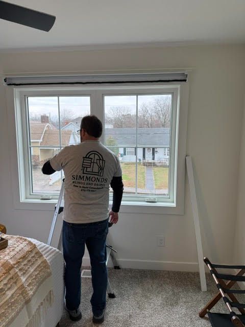 Sean Simmonds is installing window treatments at a home - simmonds blinds and shades