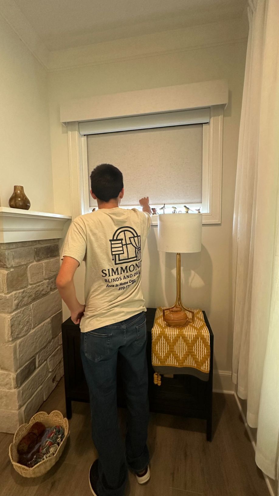 A Simmonds family member examins a roller shade - simmonds blinds and drapes, KY
