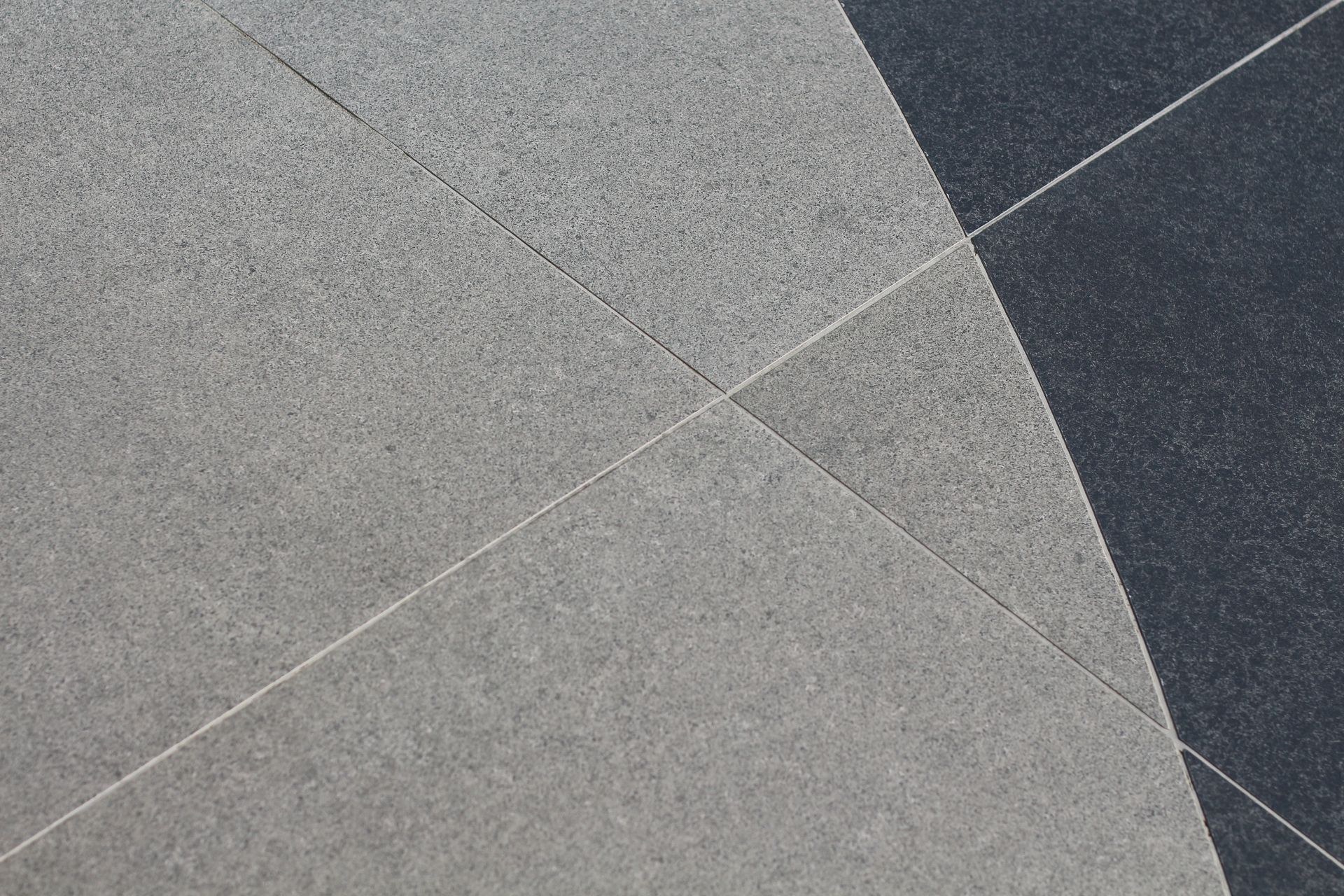 Abstract gray and dark textured geometric surface with intersecting diagonal lines Abstract gray and dark textured geometric surface with intersecting diagonal lines