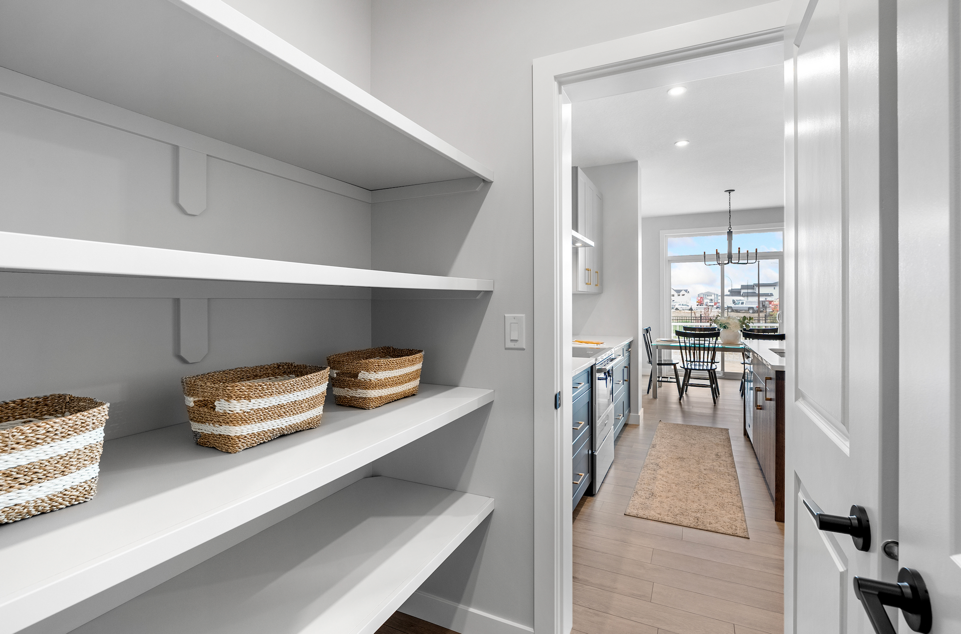 Modern co-working office space with desks, chairs, large windows, and natural light.