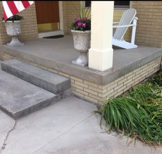 A porch with a chair and a flag on it