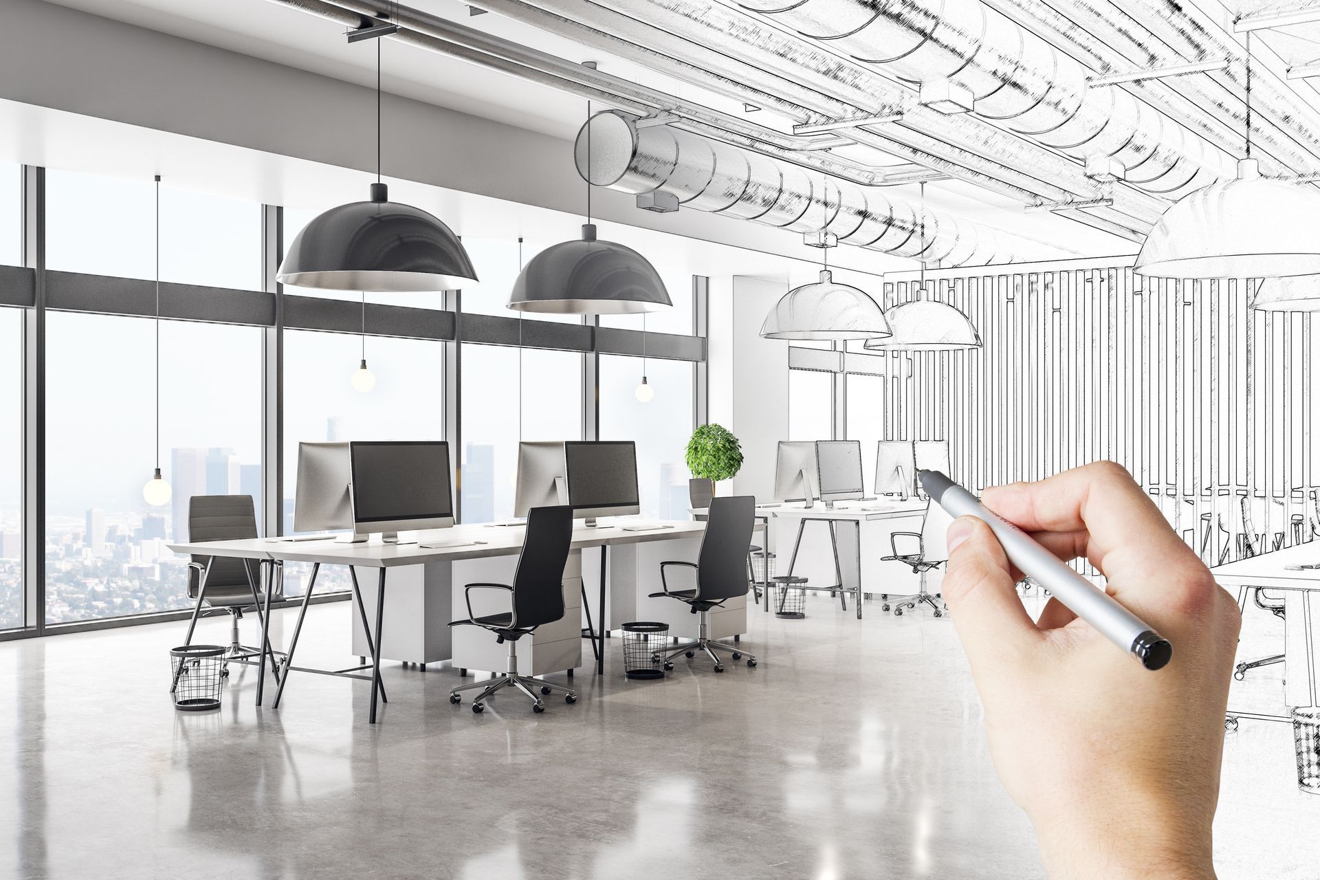 Hand drawing architectural plans of a modern office interior with desks, computers, and large windows.