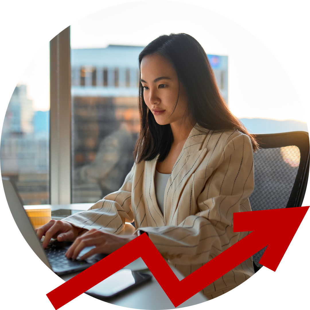 A woman is typing on a laptop with a red arrow behind her