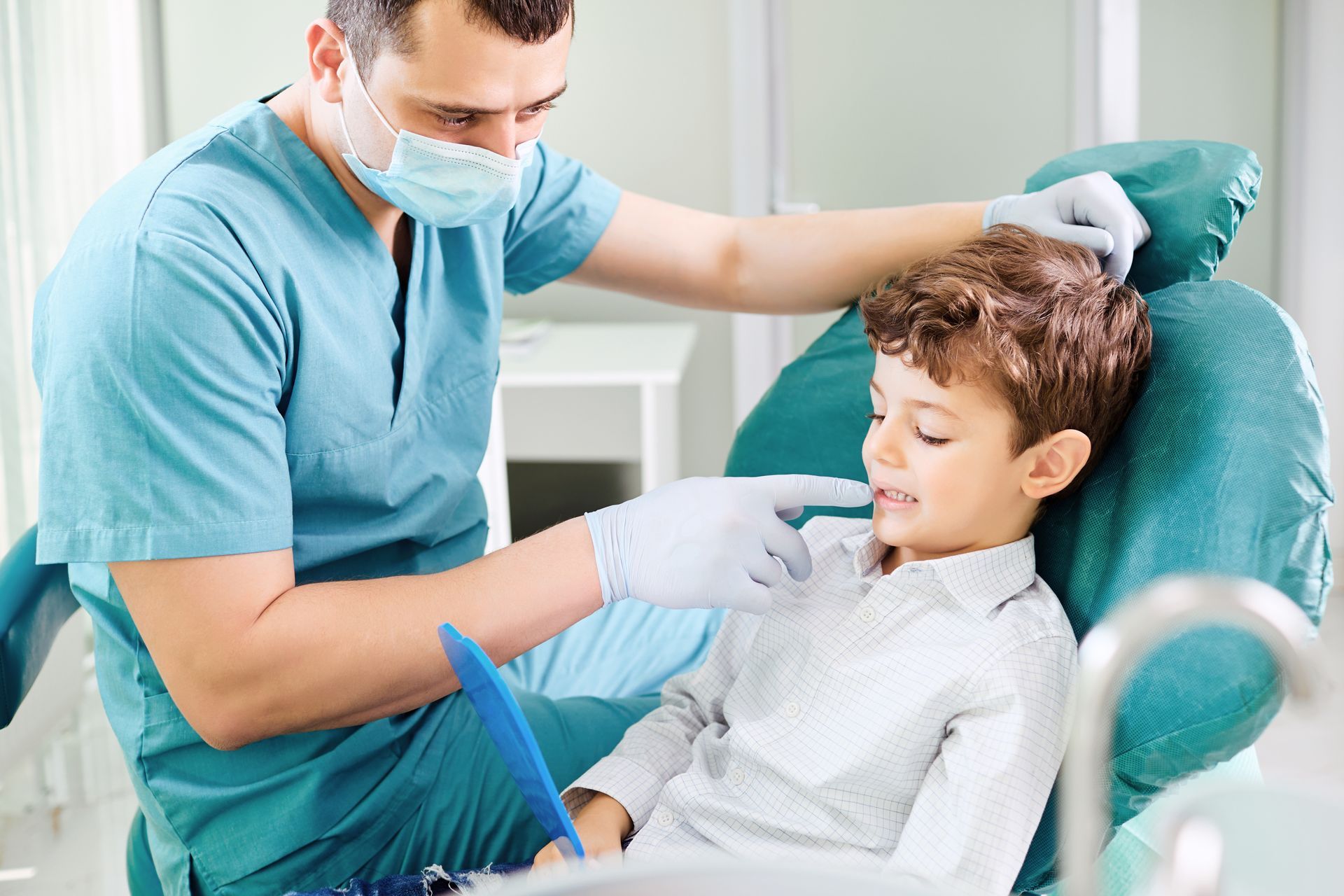 A dentist is examining a child’s teeth.