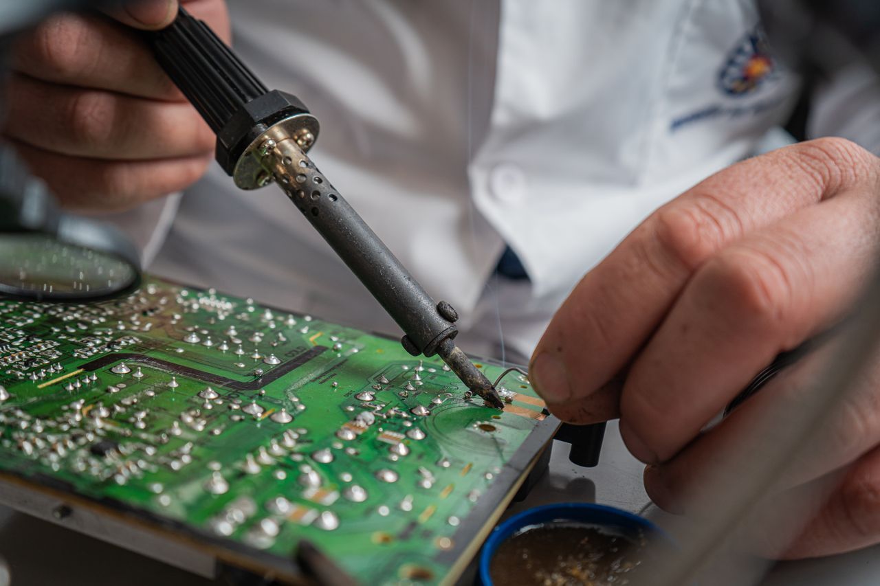 Engine control unit opened on a workbench during ECU fault testing