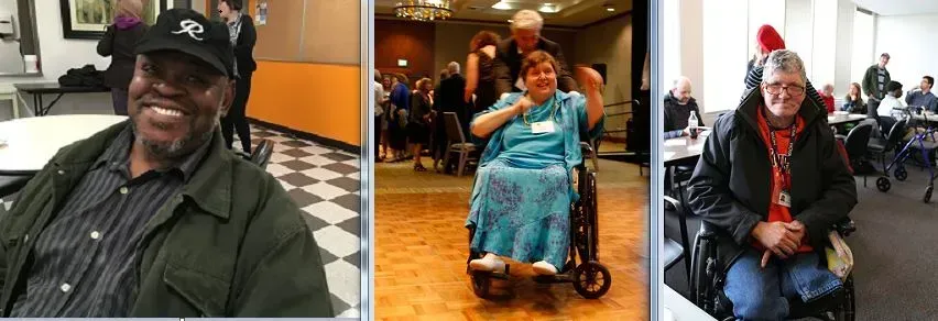 Three people, one in a wheelchair, smiling at an event, with people and tables in the background.