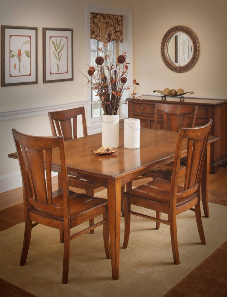 Dining room with a wooden table, four chairs, and a buffet.