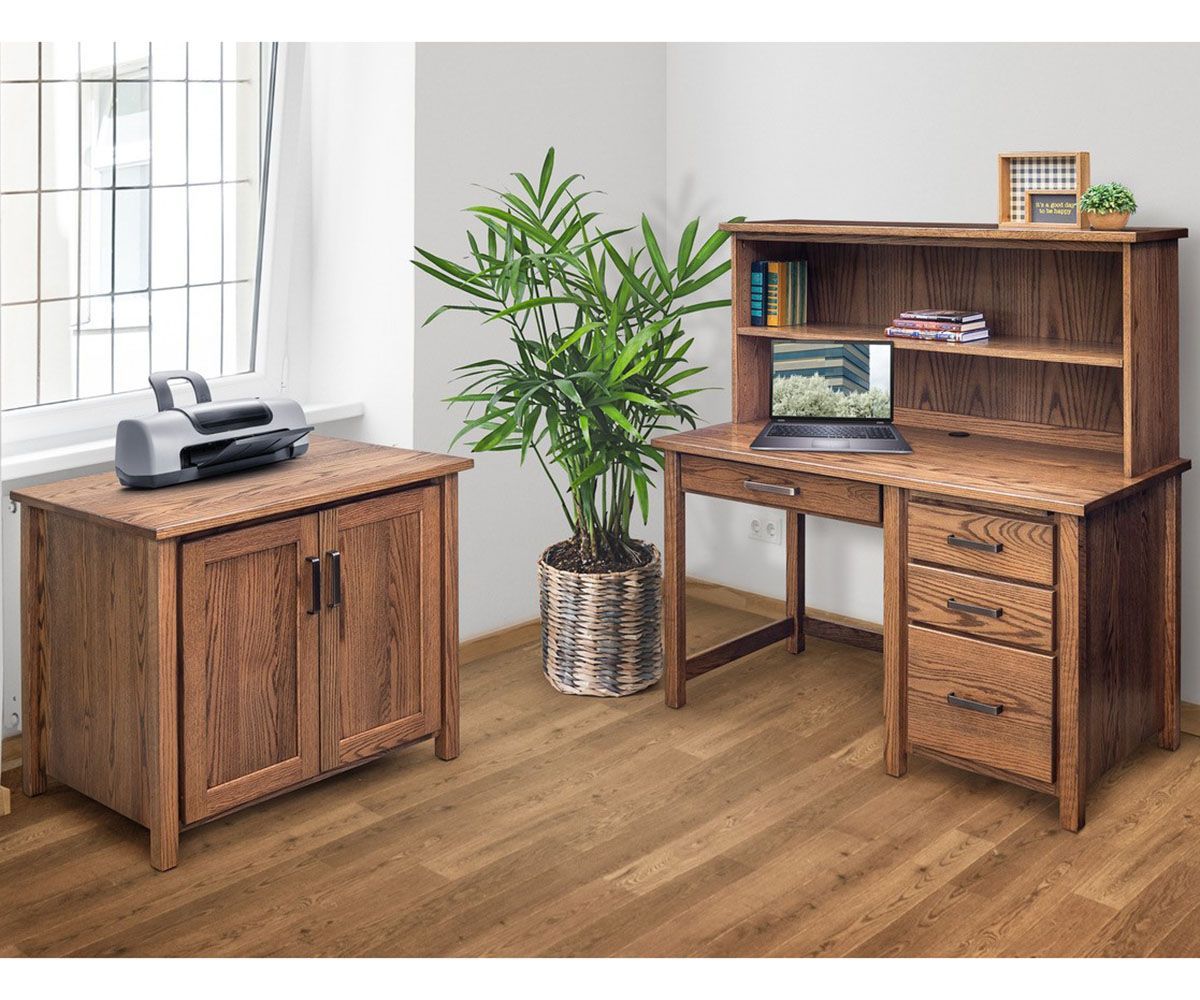 Wooden office desk with hutch, file cabinet, printer, and plant in a room with a window.
