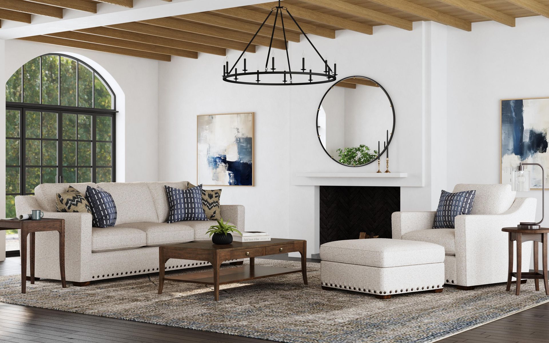Living room with neutral furniture, rug, fireplace, arched window, and abstract art.