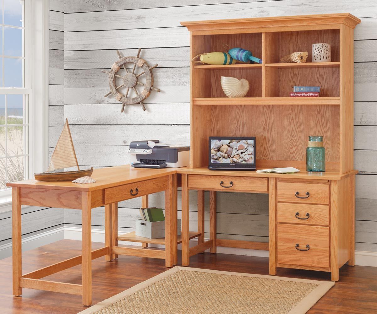 Wooden desk with hutch and sailboat decor in a room with a nautical theme.