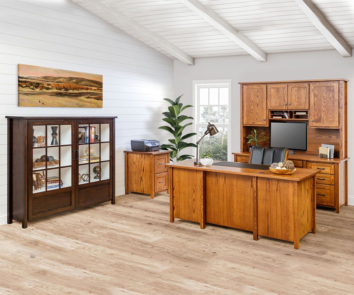 Wooden office furniture in a bright room with a desk, cabinet, and display case.