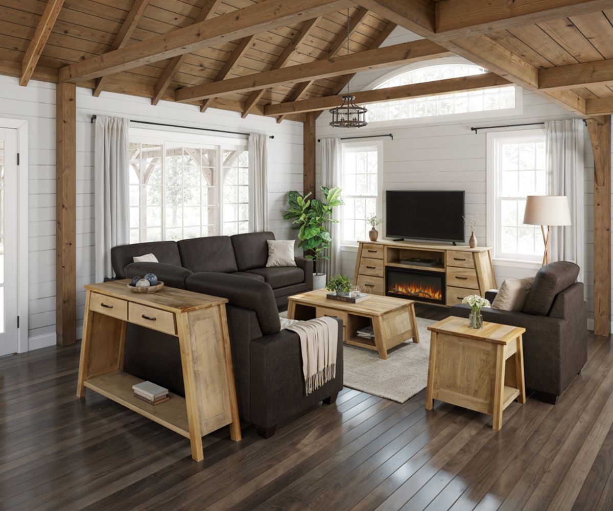 Living room with brown furniture, wooden beams, fireplace, and light wood tables.