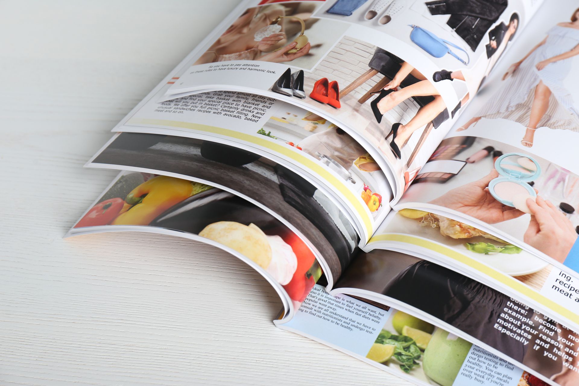 Open Magazines with Colorful Fashion and Food Photos on A White Surface — Digi Print Pro in Ballina, NSW
