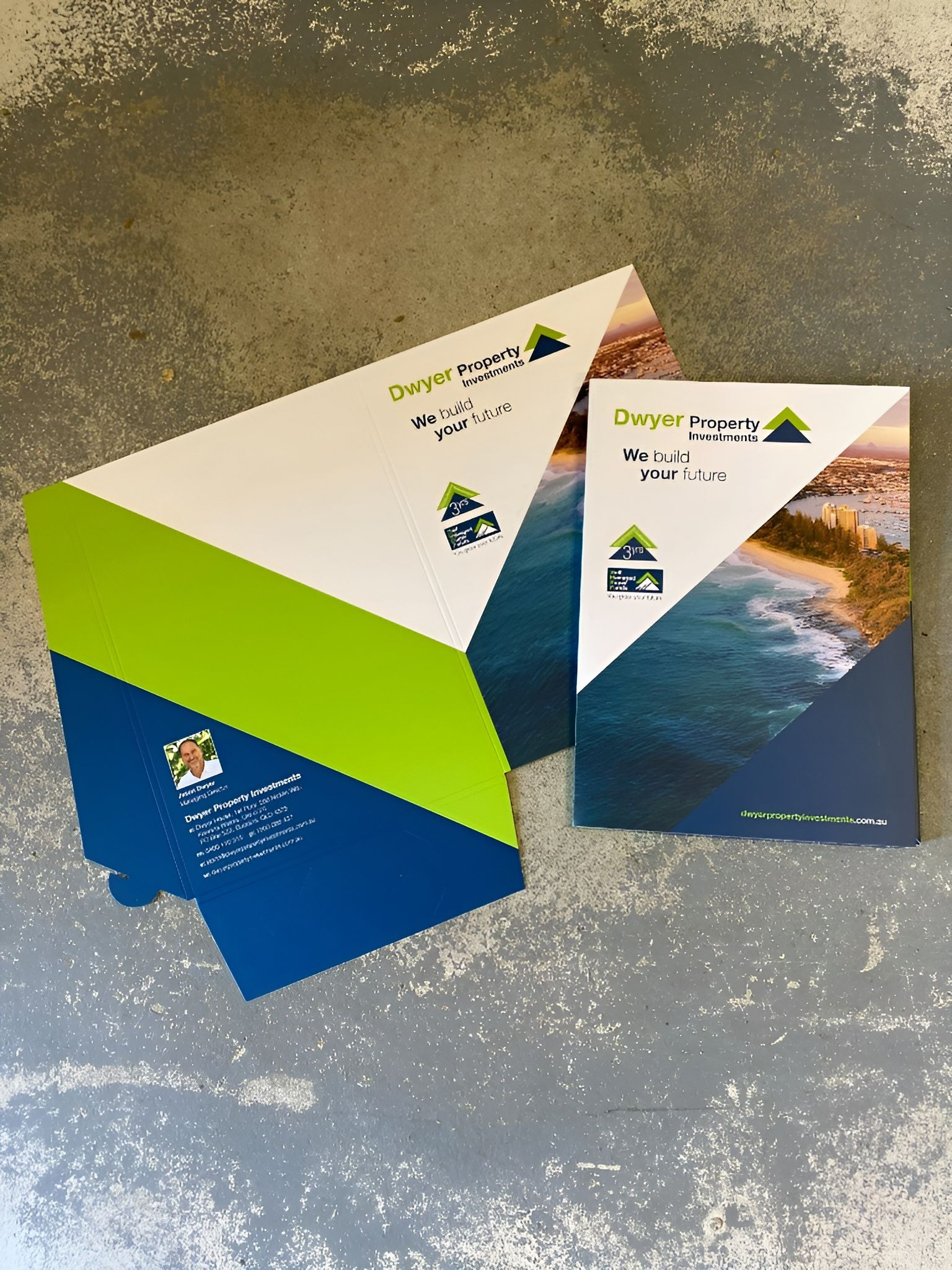 A Folder and Brochure with A Blue, Green, and White Geometric Design — Digi Print Pro in Lismore, NSW