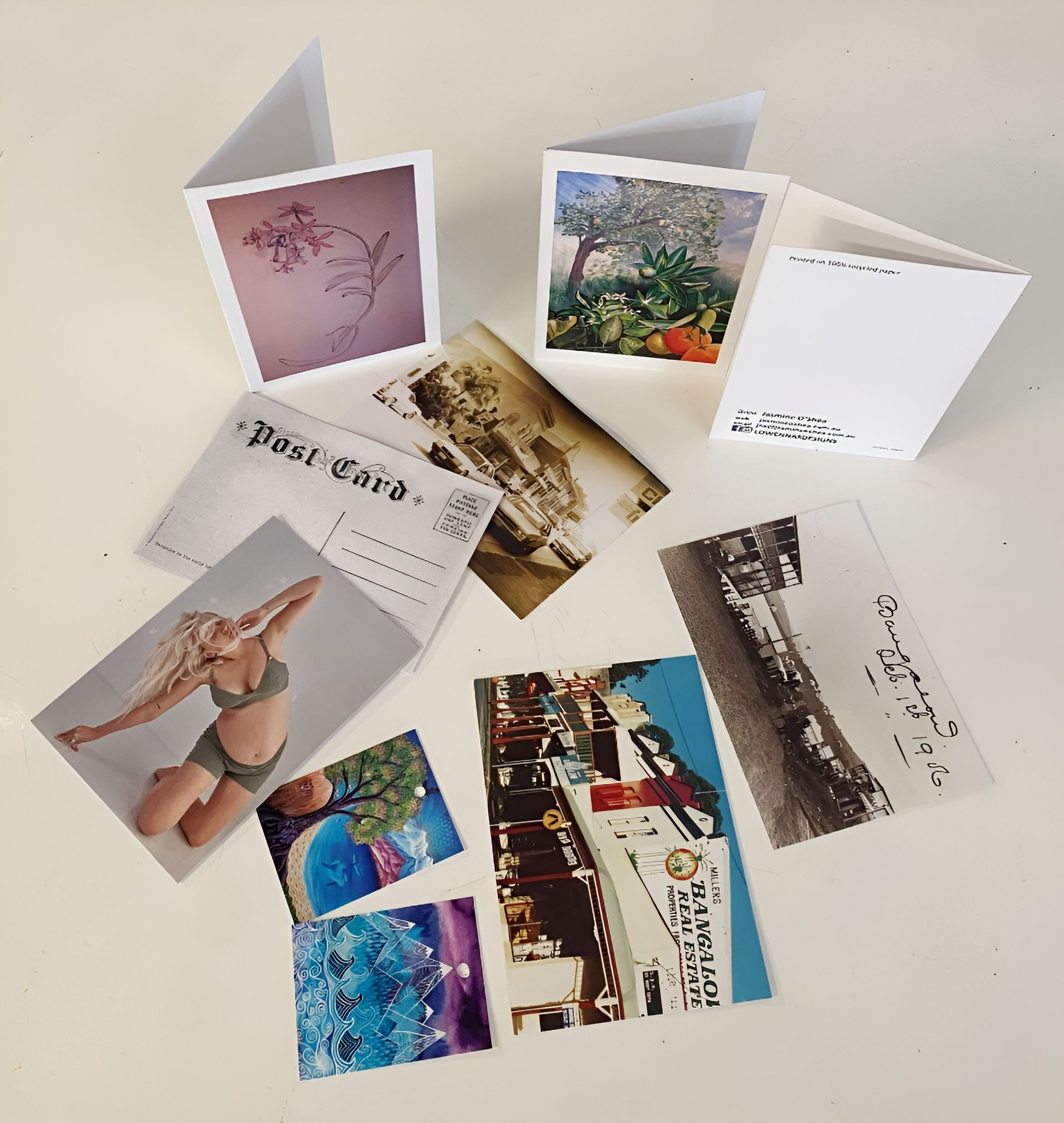 Collection of Cards and Postcards with Various Images Scattered on A White Surface — Digi Print Pro in Bangalow, NSW