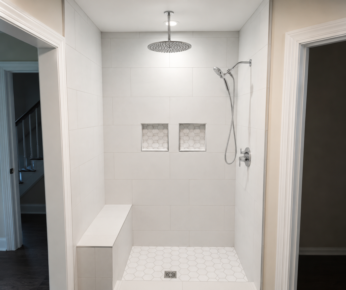 Walk-in shower with white tile, rain showerhead, and two recessed niches in a bathroom.