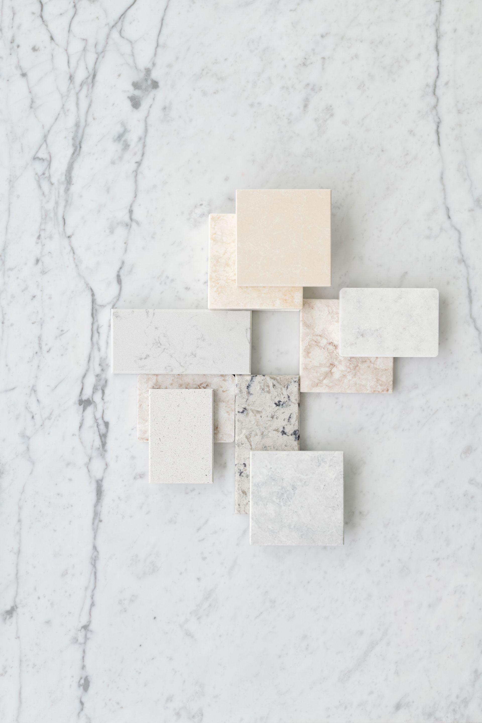 Abstract geometric wall art in cream, white, and beige on a marble background