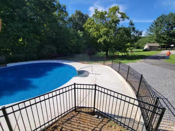 A swimming pool with a black fence around it