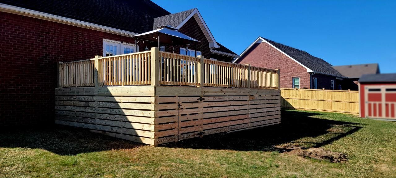 A large wooden deck is in the backyard of a house.