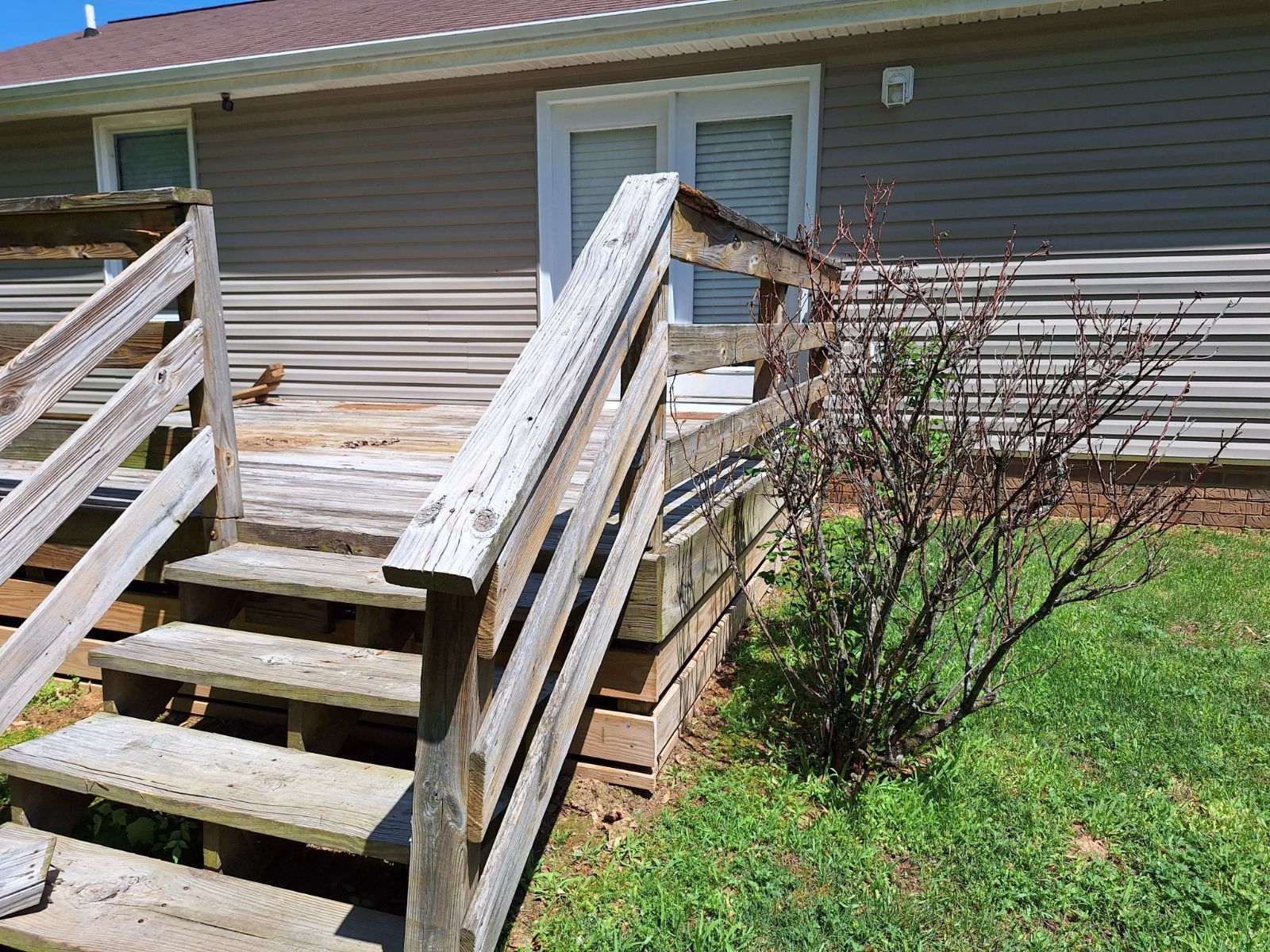 A wooden deck with stairs leading up to it