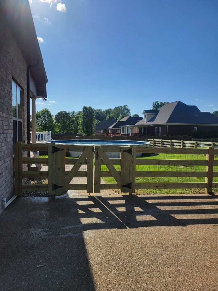 A wooden fence with a pool in the background