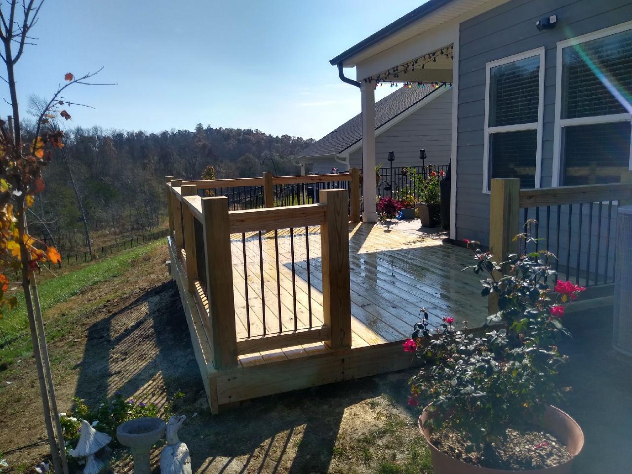 A house with a wooden deck in front of it