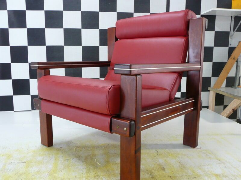 A Red Leather Chair Is Sitting In Front Of A Checkered Wall — Stitch Master in Manunda, QLD