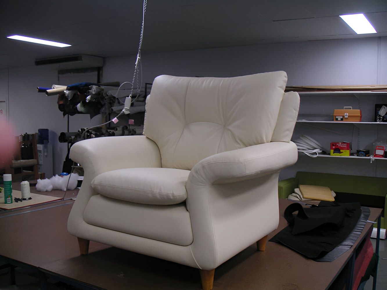 A White Leather Chair Is Sitting On A Wooden Table — Stitch Master in Manunda, QLD
